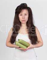 The young beautiful woman with the fresh vegetables