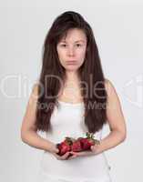 The young beautiful woman with the fresh strawberries