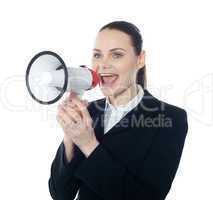 Pretty lady giving instructions with megaphone