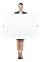 Confident young executive with an advertising board