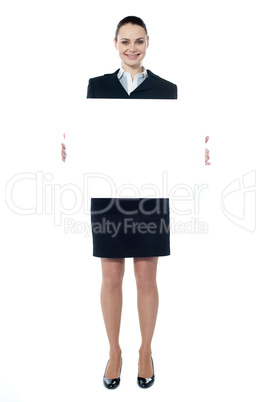 Caucasian businesswoman holding a blank billboard