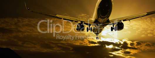 Passenger jet landing against amber sky
