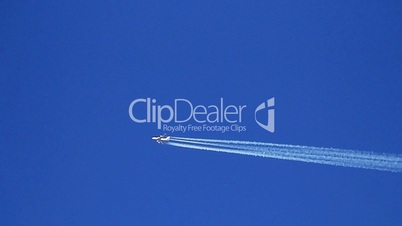 Airplane vapor trails against a clear blue sky 1