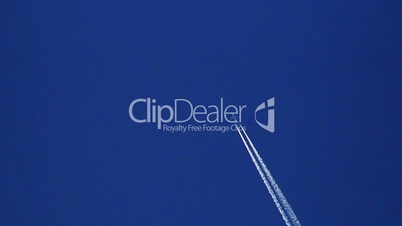 Airplane vapor trails against a clear blue sky 3