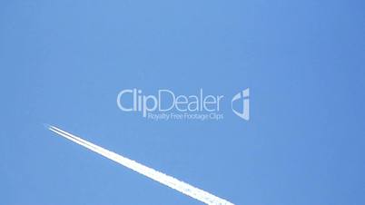 Airplane vapor trails against a clear blue sky 4