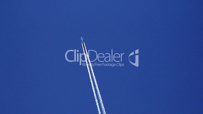 Airplane vapor trails against a clear blue sky 6