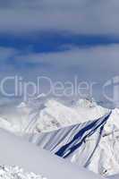 Ski slope and snowy mountains