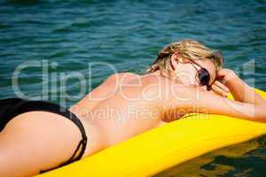 Summer woman sunbathe on water floating mattress