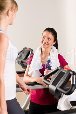 Young female friends chatting in fitness center