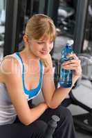 Health club young woman relax at machine