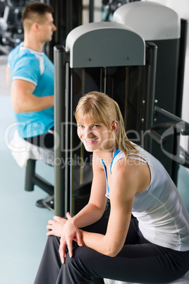 Two people at fitness center exercise machine