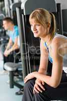 Two people at fitness center exercise machine