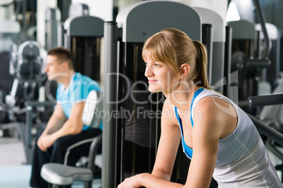 Two people at fitness center exercise machine