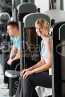 Two people at fitness center exercise machine