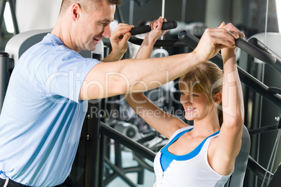 Young woman exercise on shoulder press machine