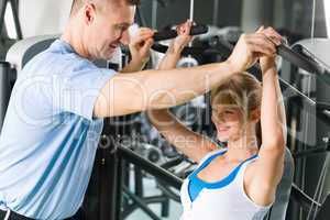 Young woman exercise on shoulder press machine