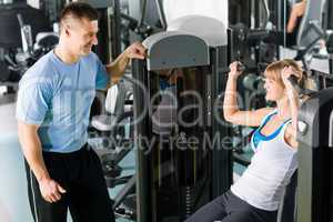 Young woman exercise on shoulder press machine