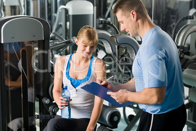 Completing personal fitness plan with trainer