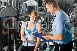 Completing personal fitness plan with trainer