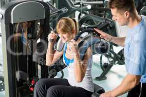 Fitness center young woman exercise with trainer