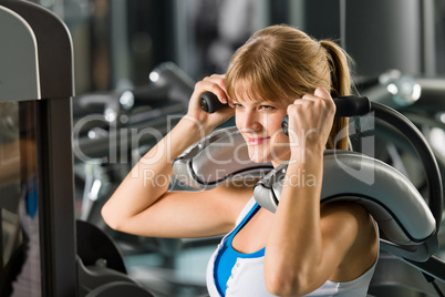 Young woman at fitness center exercise abdominal