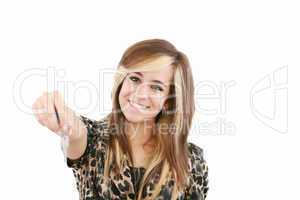 Smiling woman gives over house key. Isolated on white background