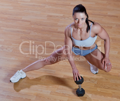 Athletic trainer shows examples of exercises in the gym