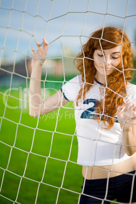 Healthy beautiful girl with freckles on soccer field