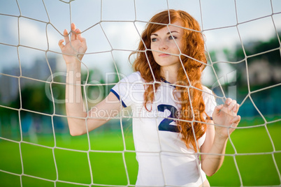 Healthy beautiful girl with freckles on soccer field
