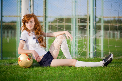 Healthy beautiful girl with freckles on soccer field