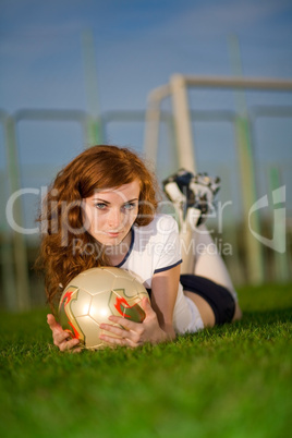 Healthy beautiful girl with freckles on soccer field