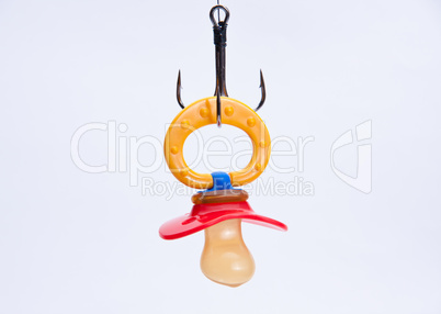 infant pacifier hangs on a hook