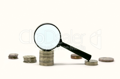 Magnifier on pile of coins
