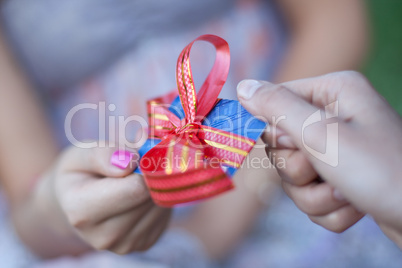 Credit card with bow as gift to young woman