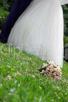 bridal bouquet lies on the grass