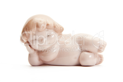 figurine of angel lying on white background