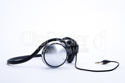 headphones with plug lie on background