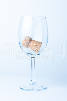 single glass of wine with cork from a bottle