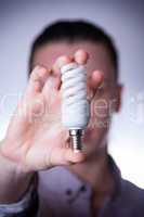 person holding energy saving lamp