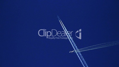 Airplane vapor trails against a clear blue sky 8