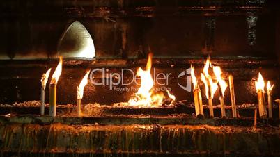 candles burning in buddhist temple