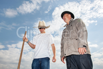 Farmer with an apprentice in the field
