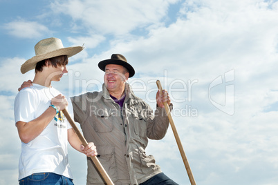 Farmer with an apprentice in the field