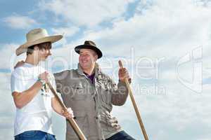 Farmer with an apprentice in the field