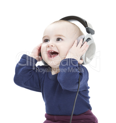 young child with ear-phones listening to music