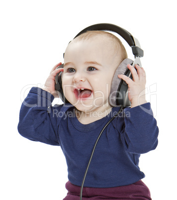 young child with ear-phones listening to music