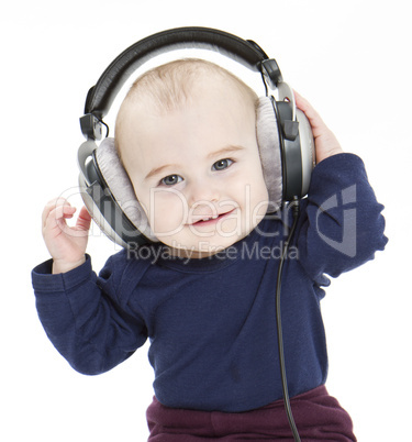 young child with ear-phones listening to music