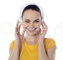 Pretty young female enjoying music