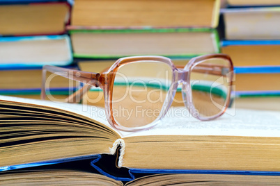 .reading glasses lying on the book