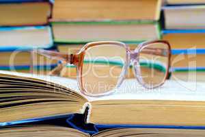 .reading glasses lying on the book